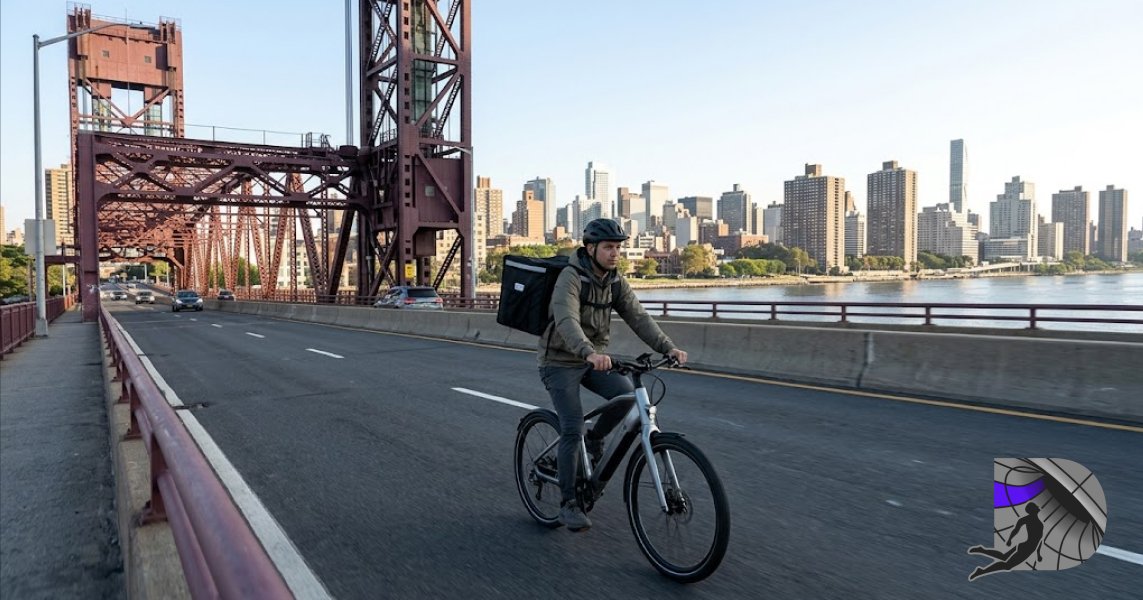 Fast cannabis courier riding an e-bike across the Roosevelt Island Bridge for local delivery.